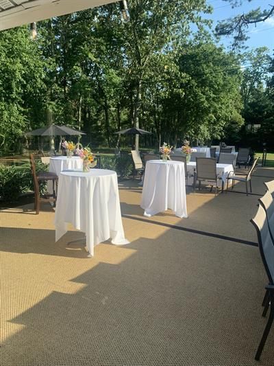 A patio with tables and chairs set up for a party.