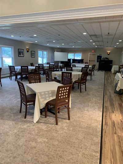 A large room with tables and chairs in it.