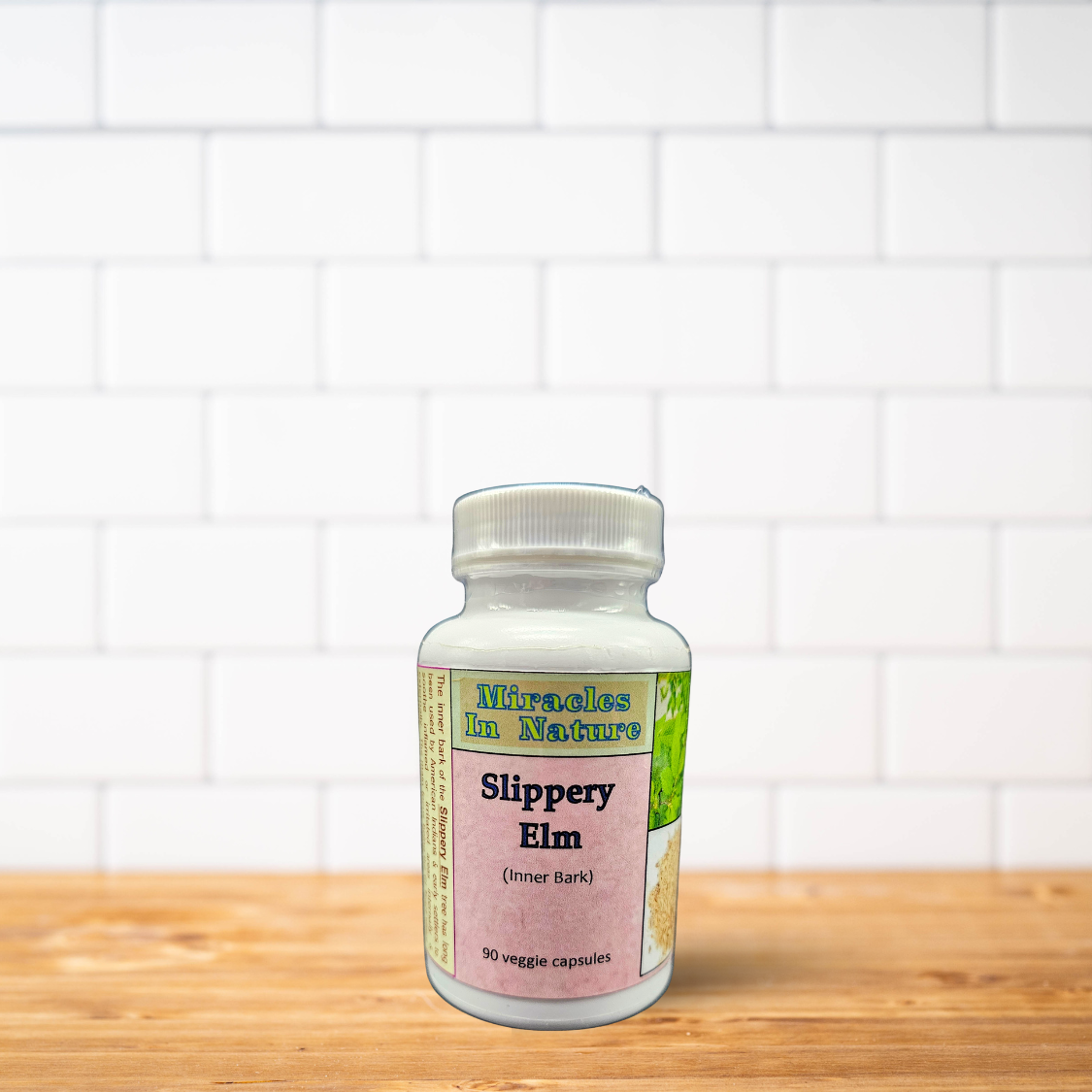 A bottle of miracles in nature women 's health is sitting on a wooden table.