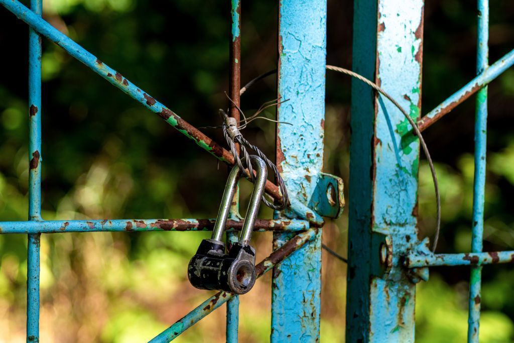 Laser clean rusty blue metal gates. 