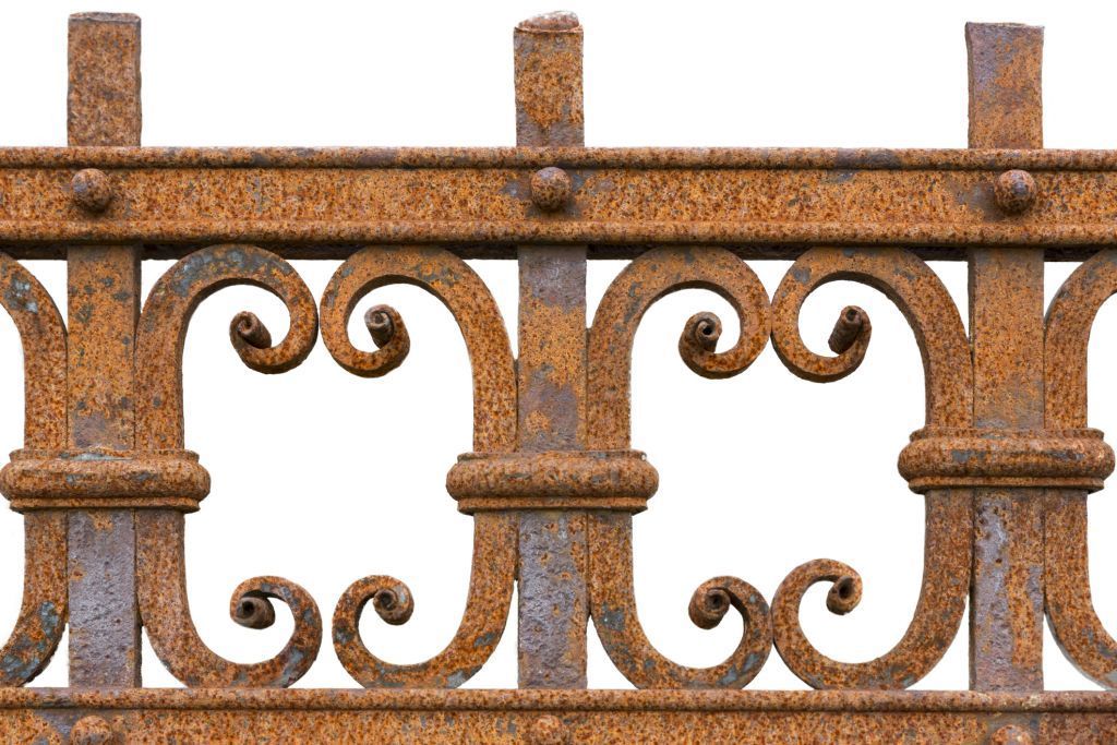 Laser and prepare rusty wrought iron fence with decorative scrolls and vertical posts.