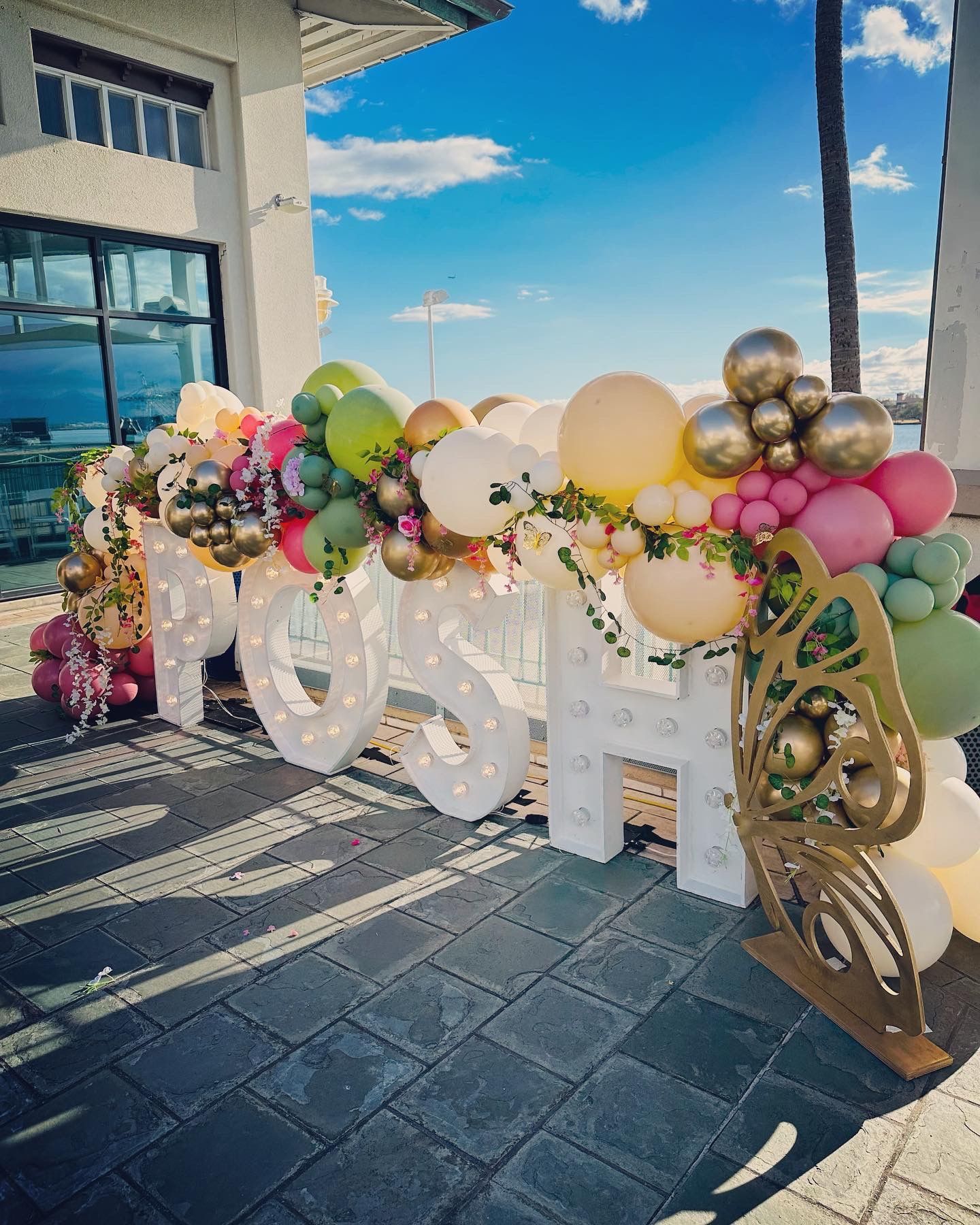 The word mosh is surrounded by balloons and flowers.