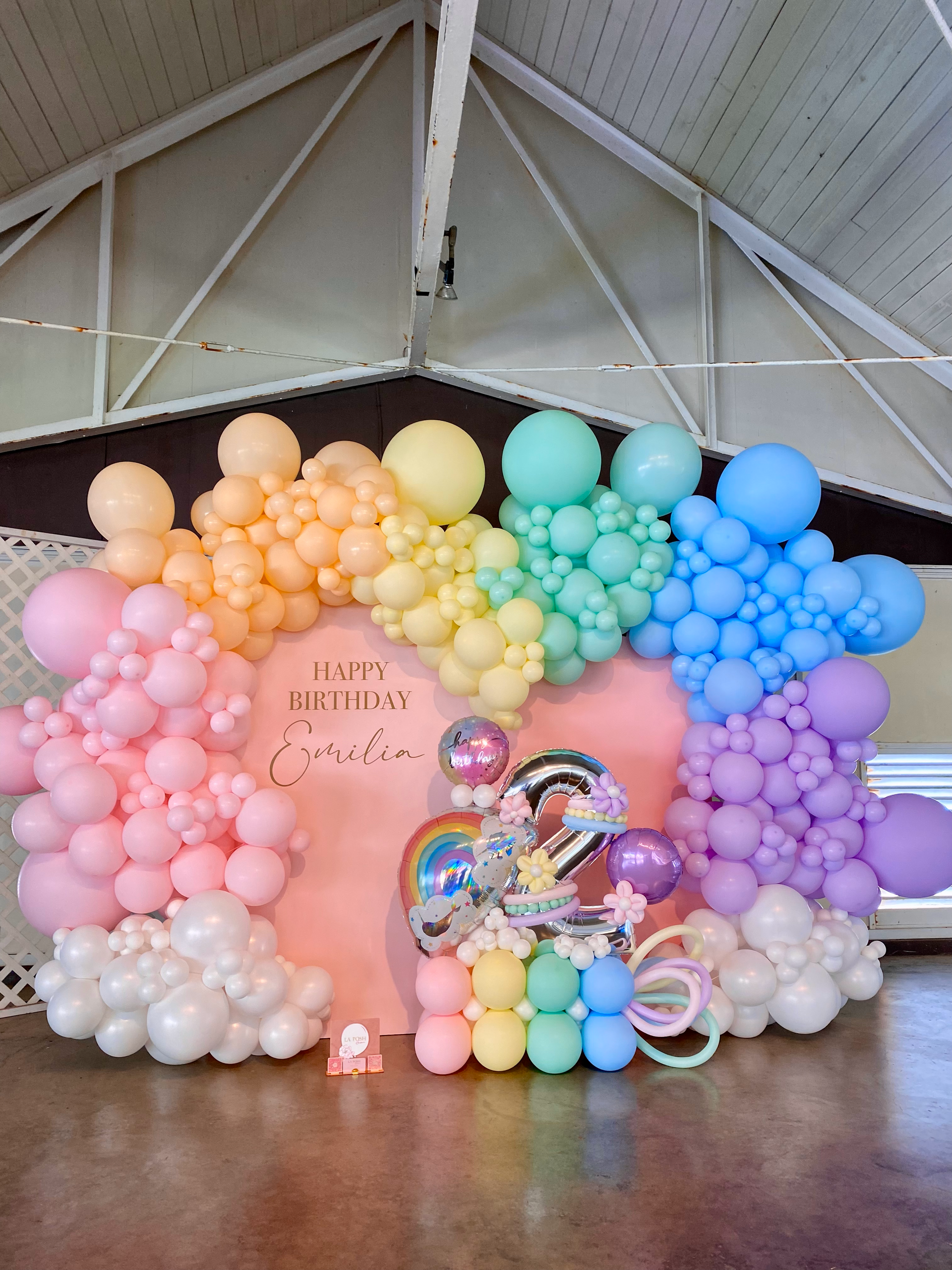 A bunch of balloons are sitting on the floor in a room.