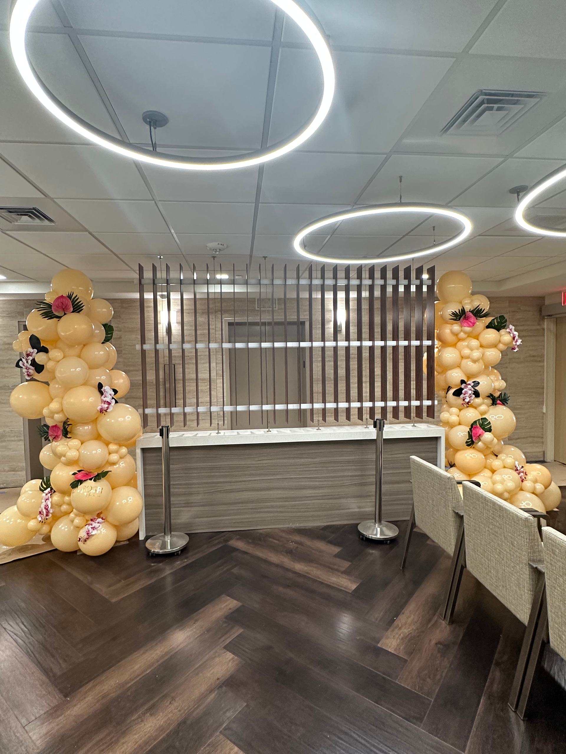 A room with a wooden floor and balloons on the wall.