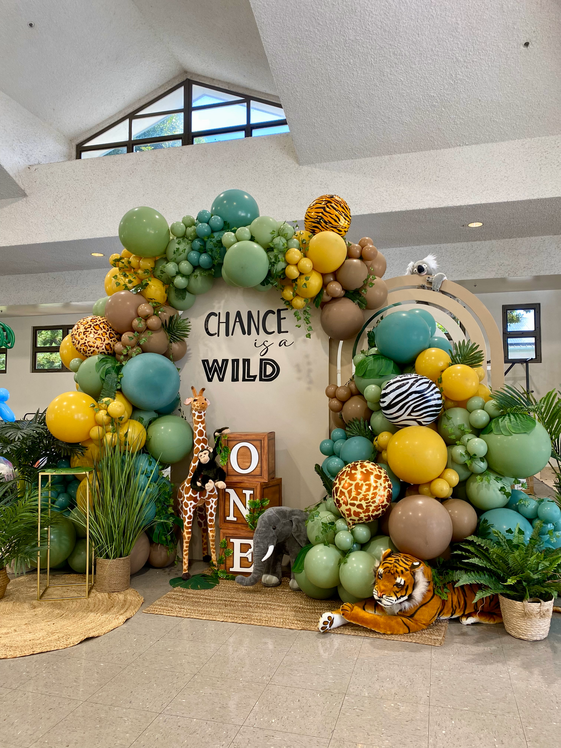 A bunch of balloons are sitting on the floor in a room.