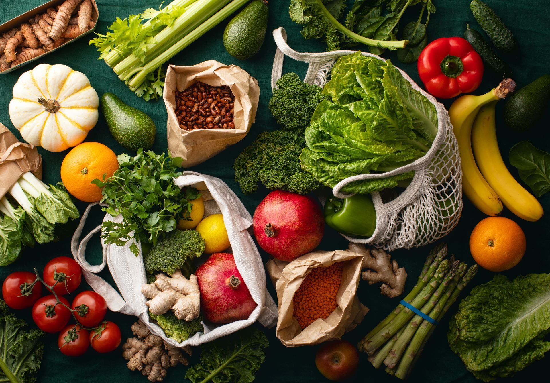 There are many different types of fruits and vegetables on the table.