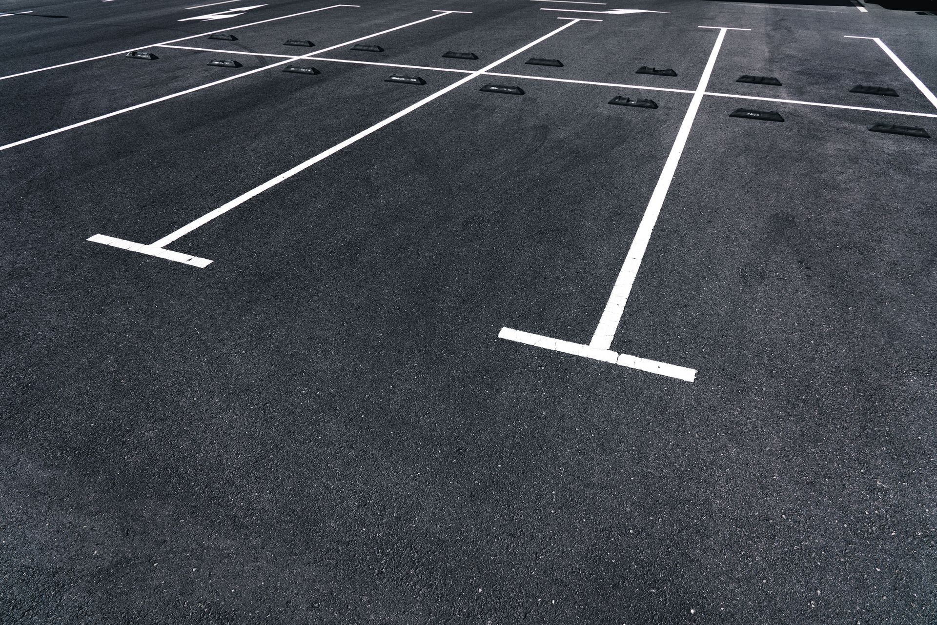An empty parking lot with white lines on it