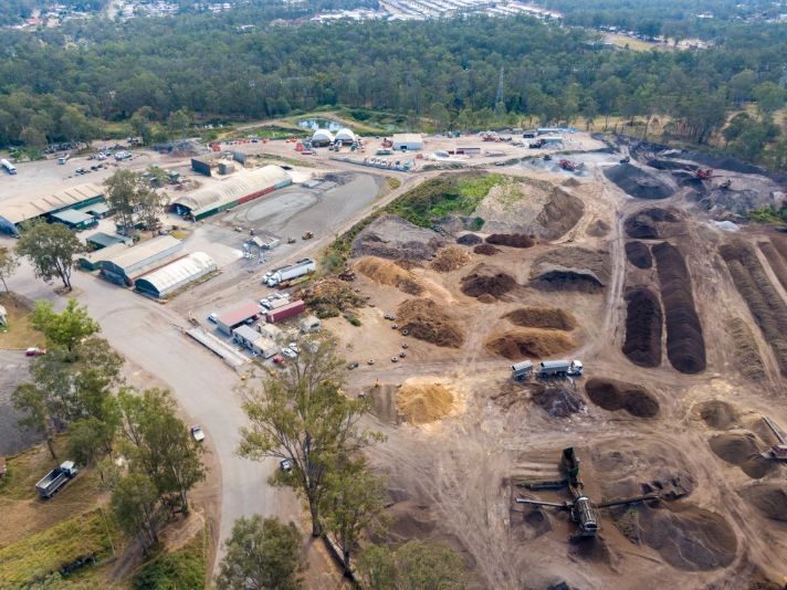 An aerial view of a large dirt field with lots of piles of dirt.