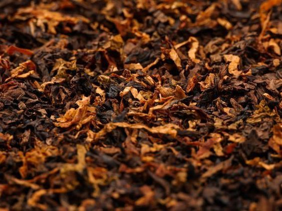 A close up of a pile of dried tobacco leaves.