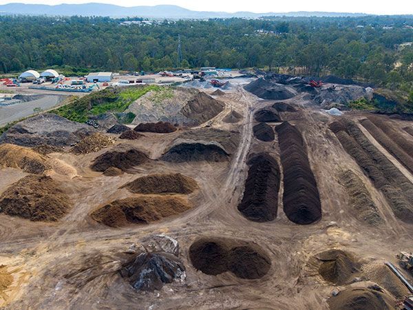 An aerial view of a pile of dirt in a field.