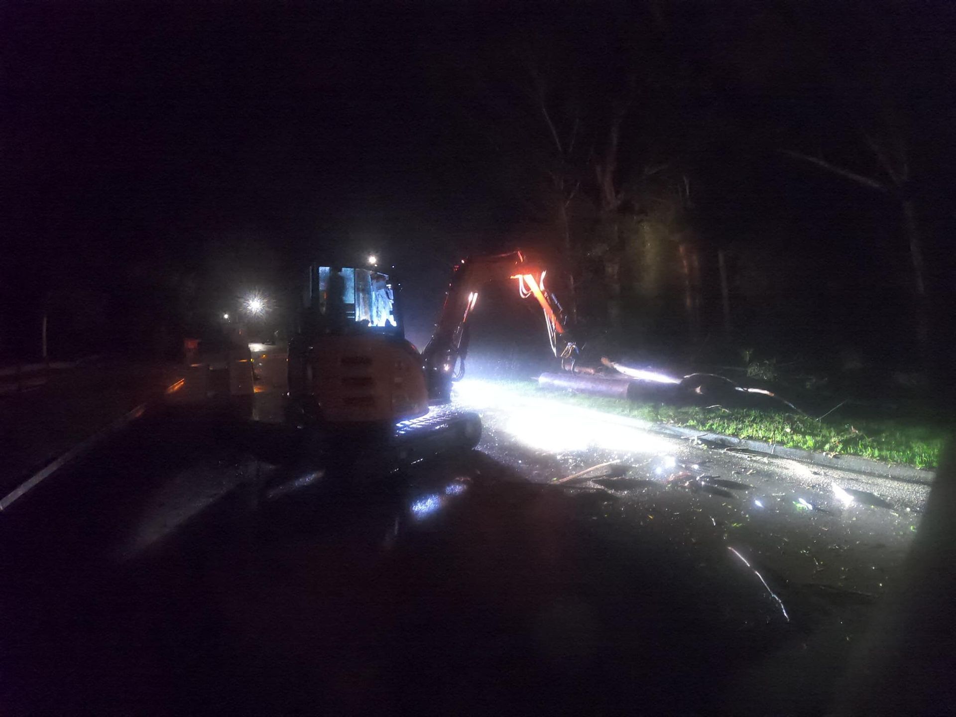 A Excavator Working at Night on a Wet Road — MNC Trees in Kempsey, NSW