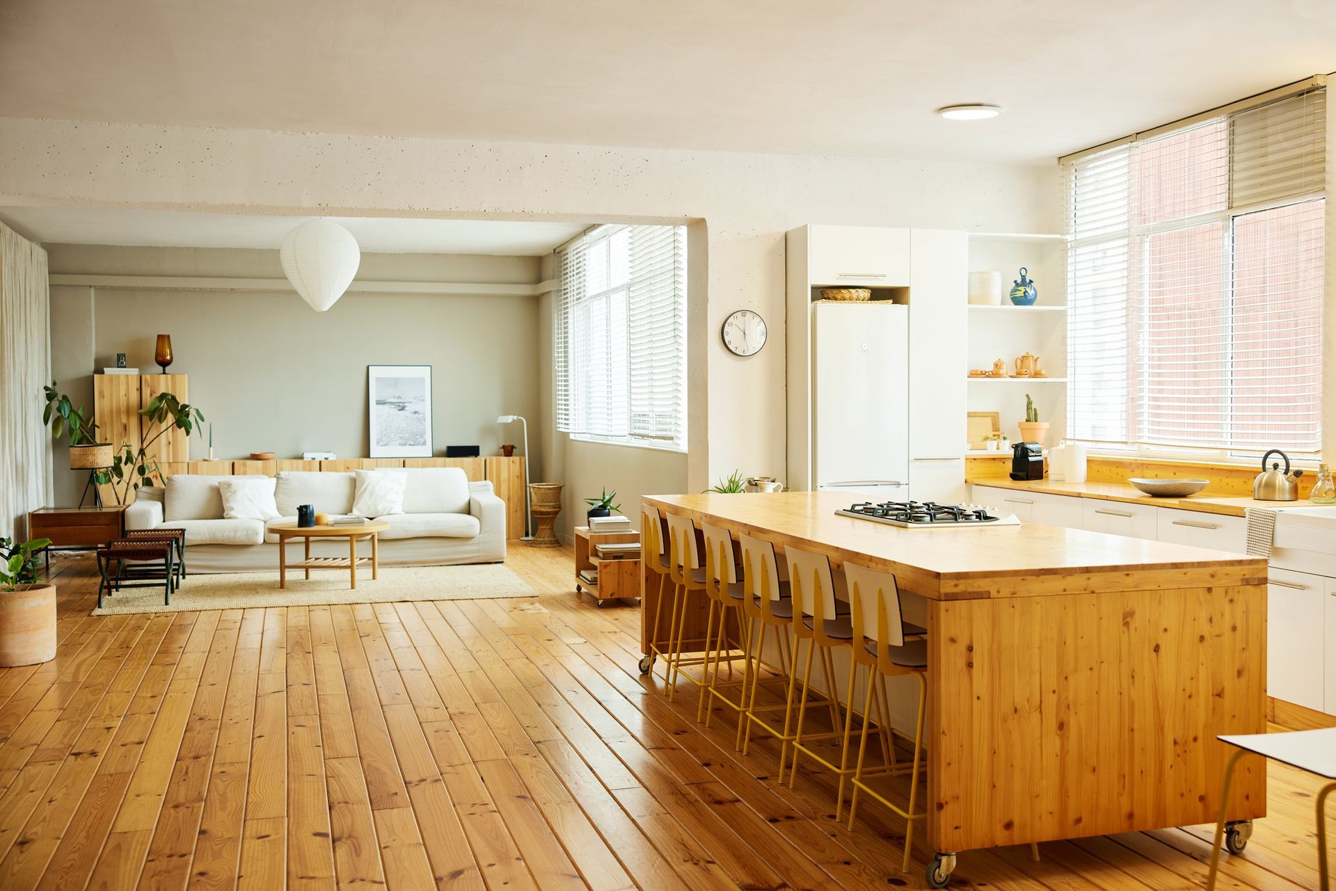 There is a large wooden island in the middle of the room.