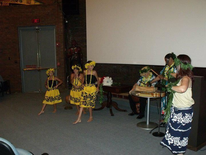 A group of people are dancing in front of a screen