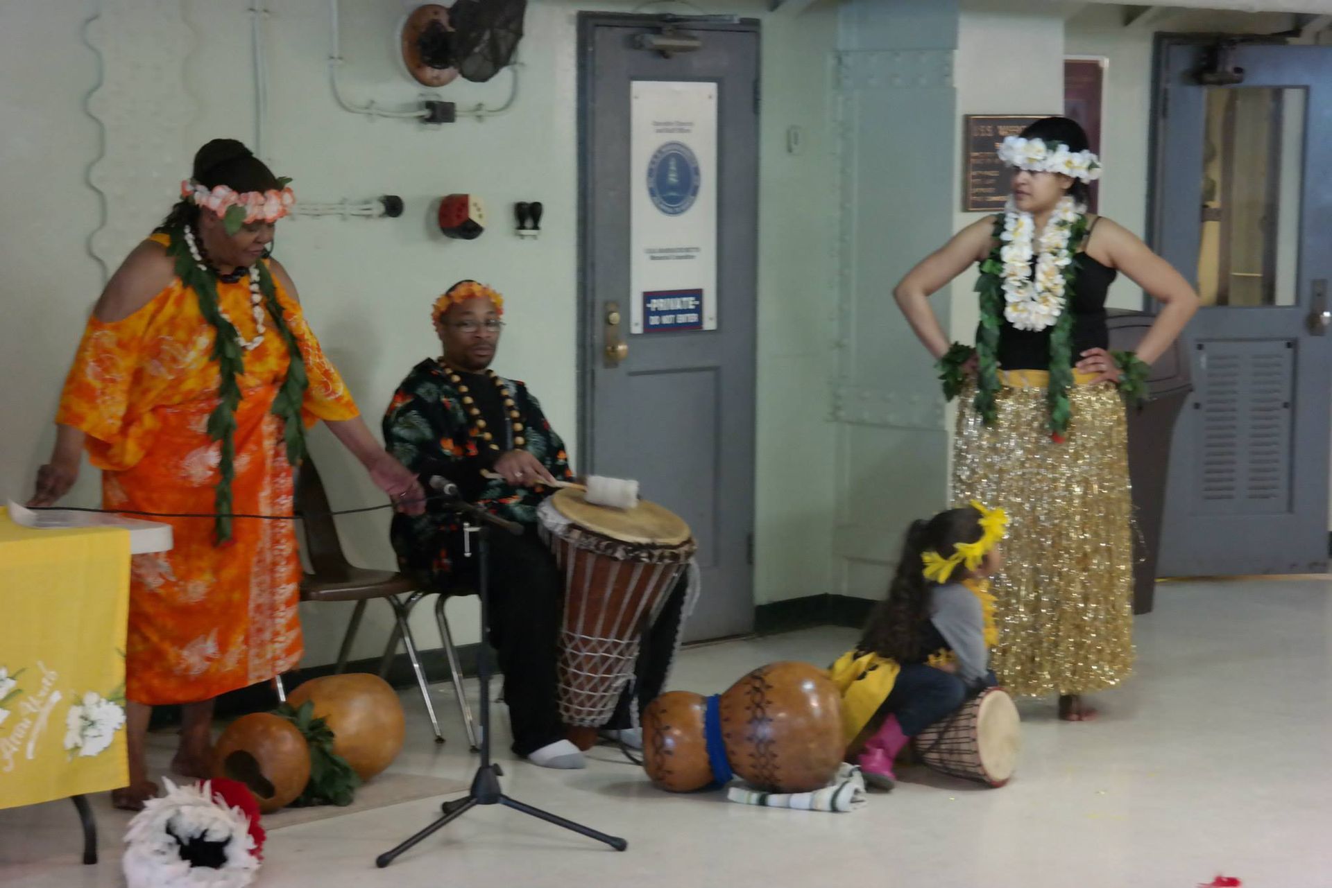 A group of people are playing drums in a room