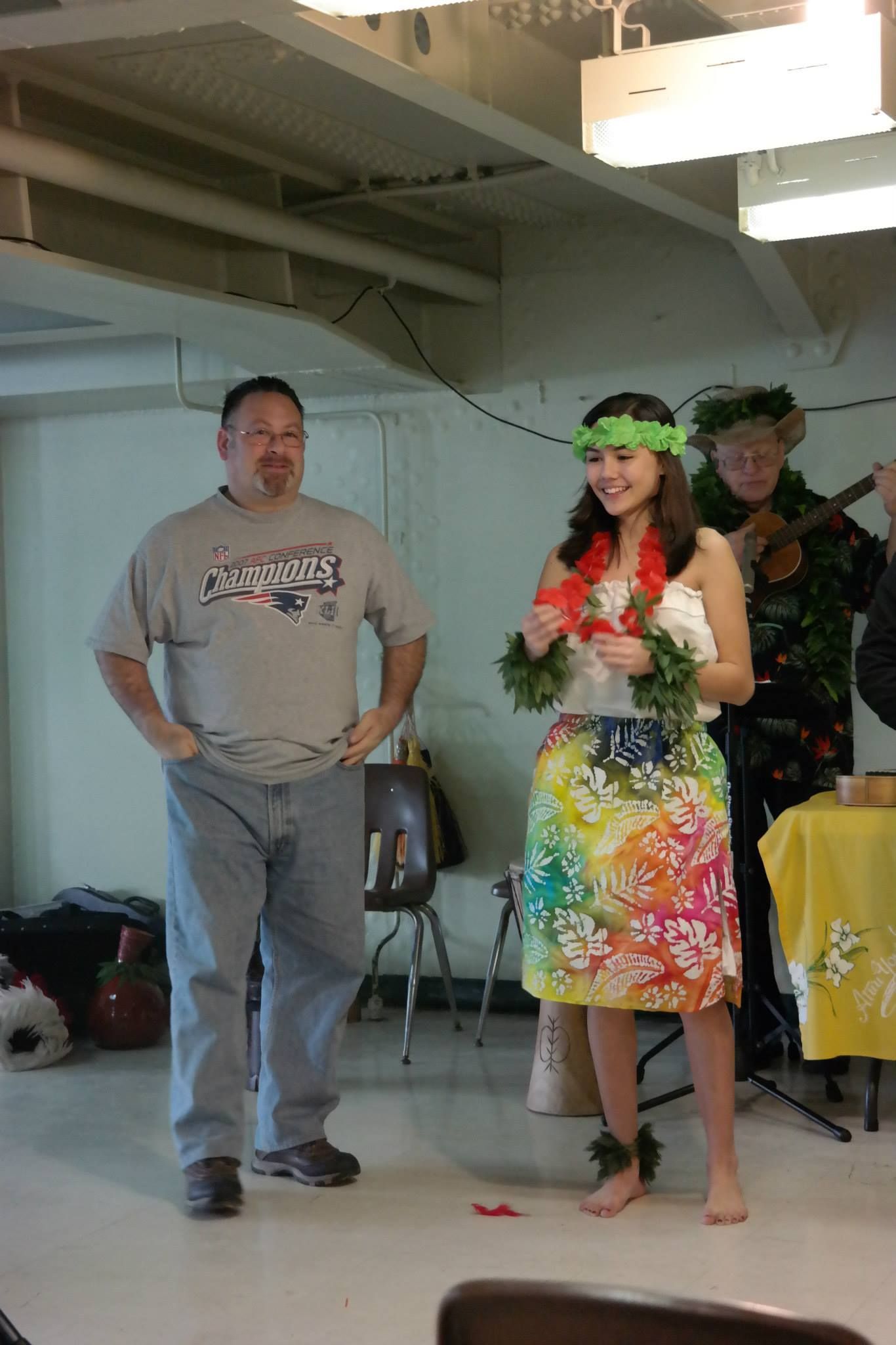 A man and a woman are standing next to each other in a room.