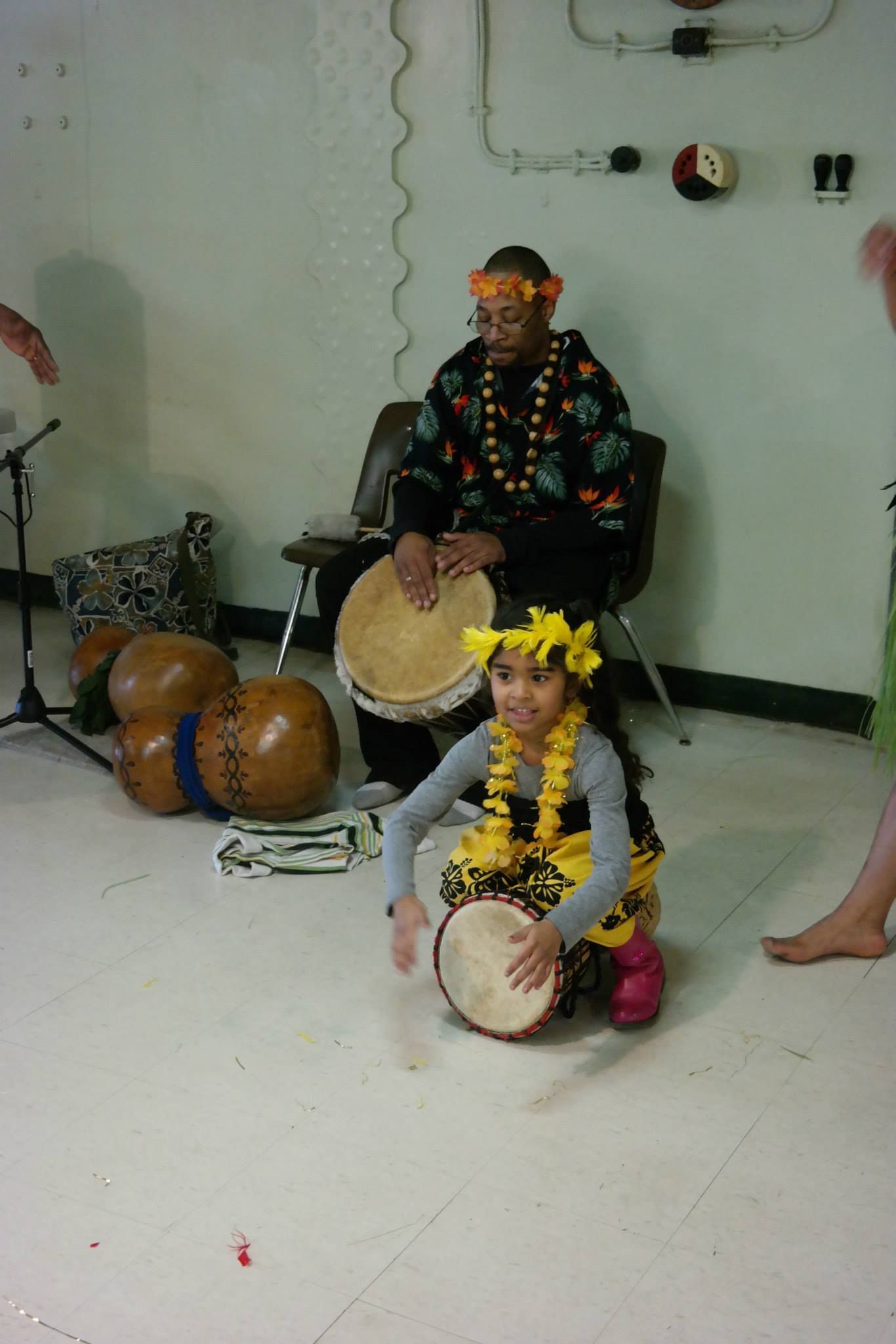 A group of people are playing drums in a room