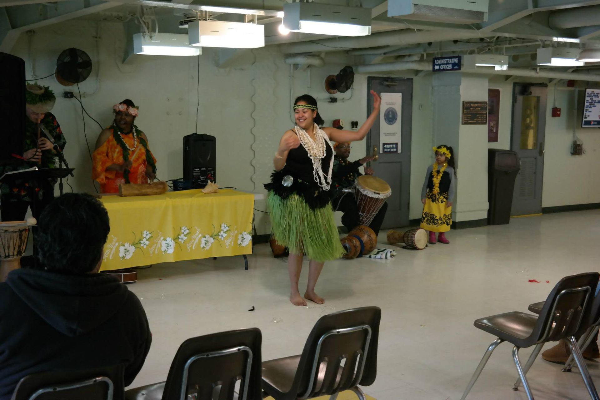 A woman is dancing in a room with people watching