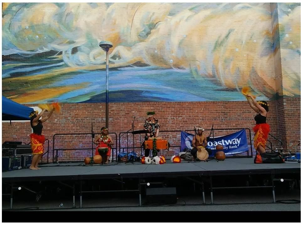 A group of people on a stage in front of a sign that says one way