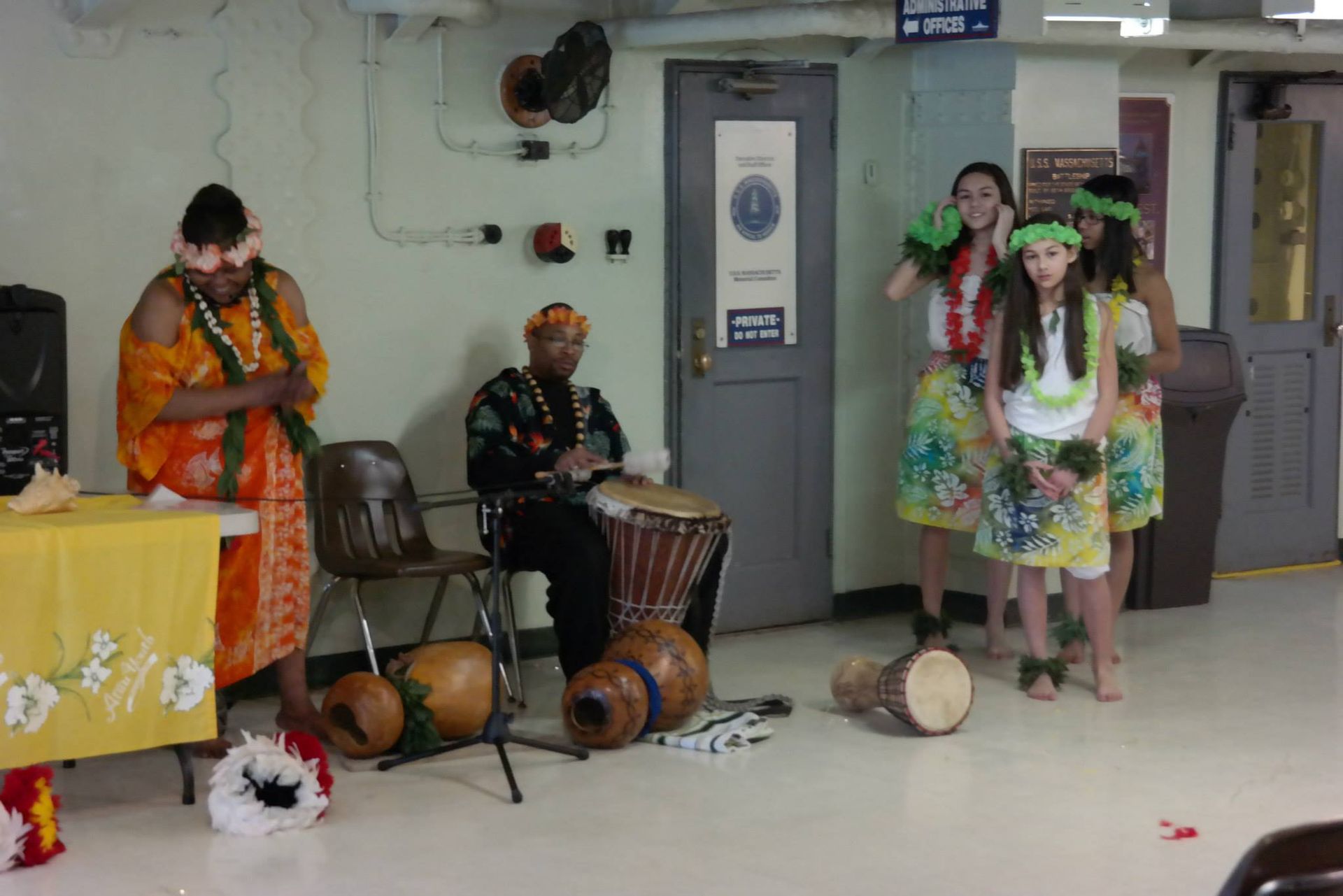 A group of people are playing drums in a room