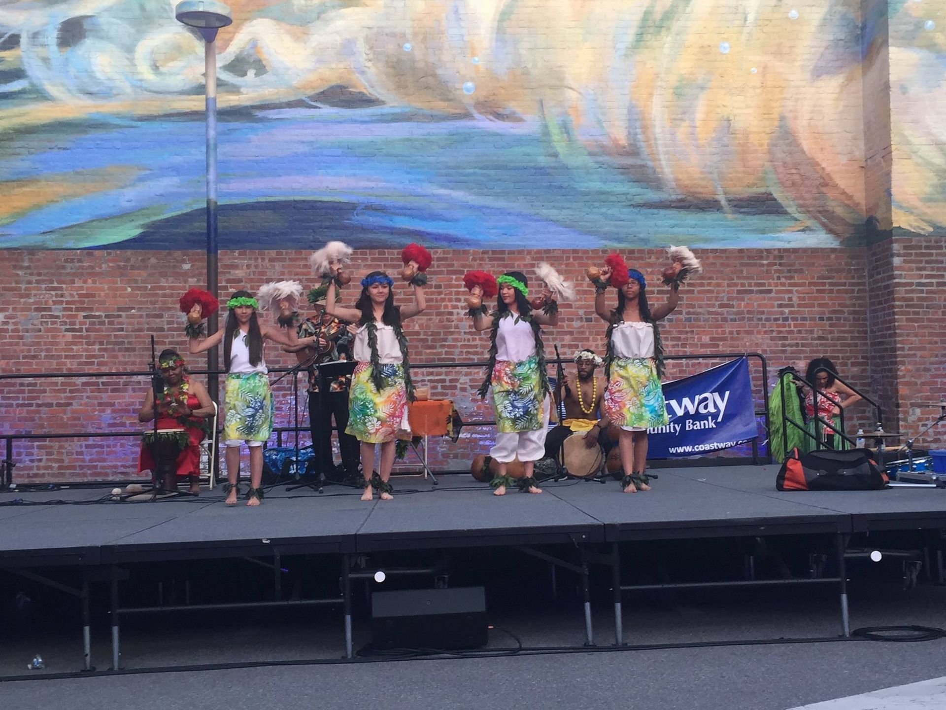 A group of girls are dancing on a stage in front of a sign that says norway