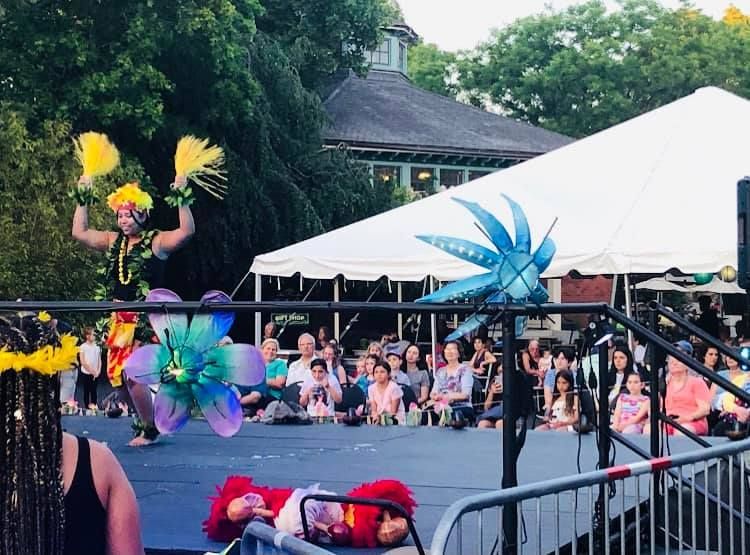 A group of people are watching a performance on a stage.