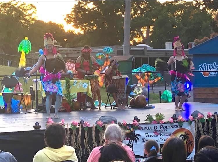 A group of people are performing on a stage in front of a crowd.