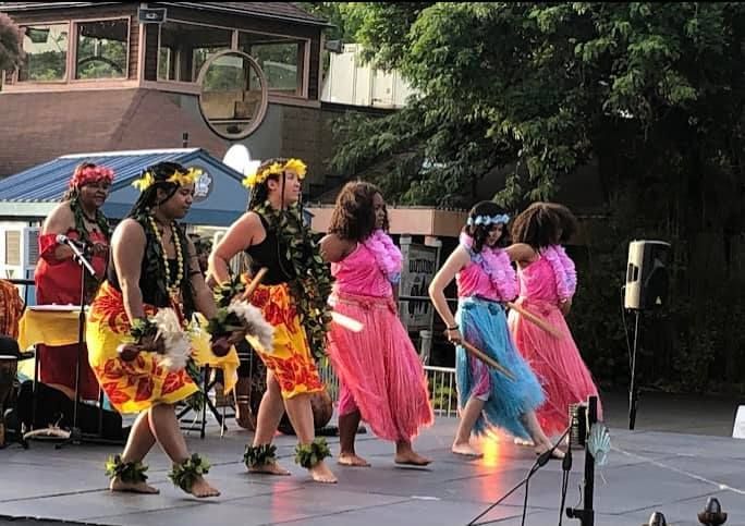 A group of people are dancing on a stage.
