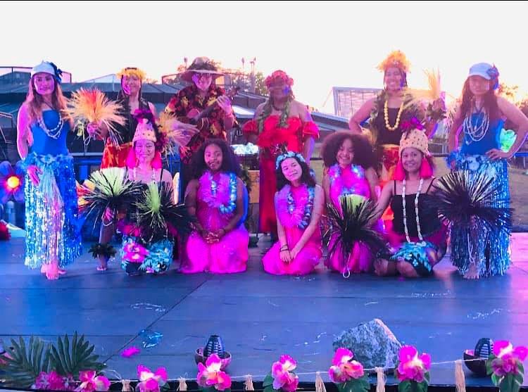 A group of people are posing for a picture on a stage.