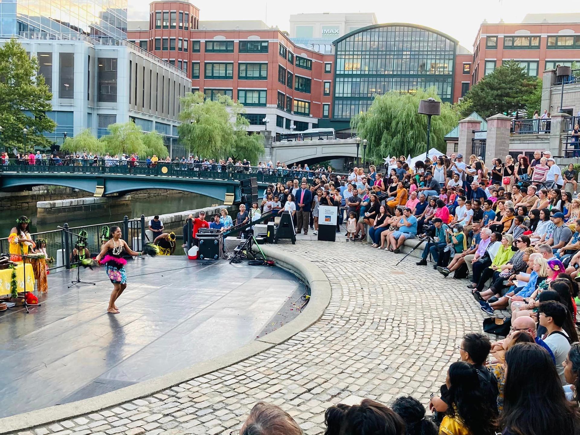 A woman is dancing on a stage in front of a crowd of people.