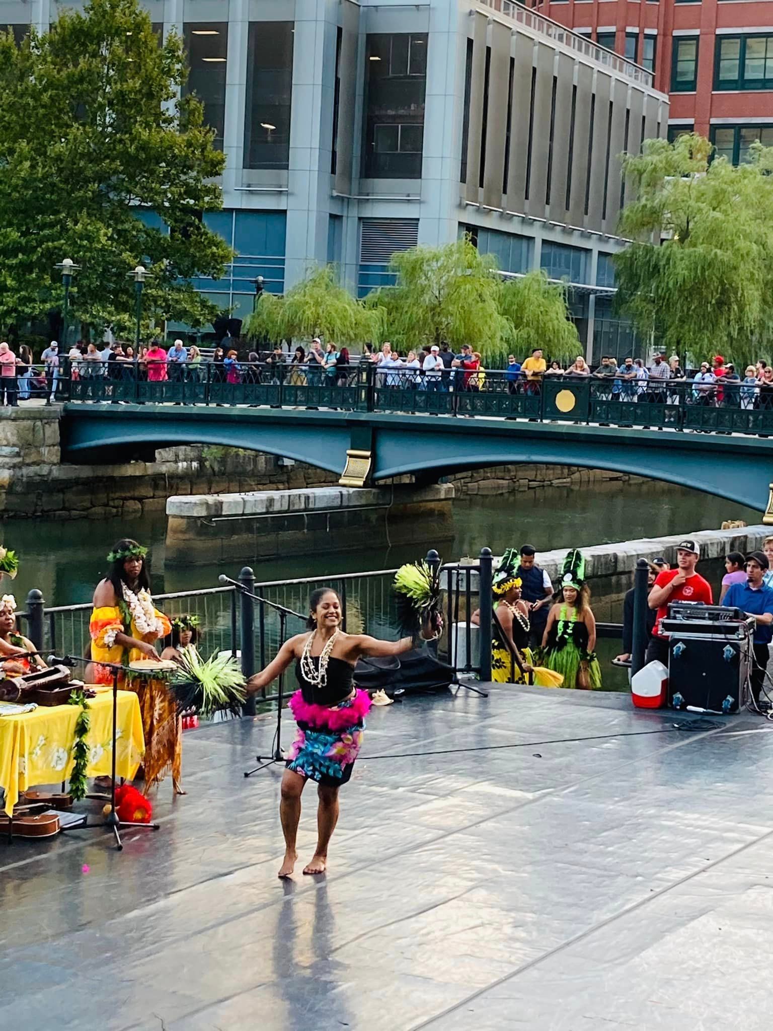 A woman is dancing in front of a crowd of people