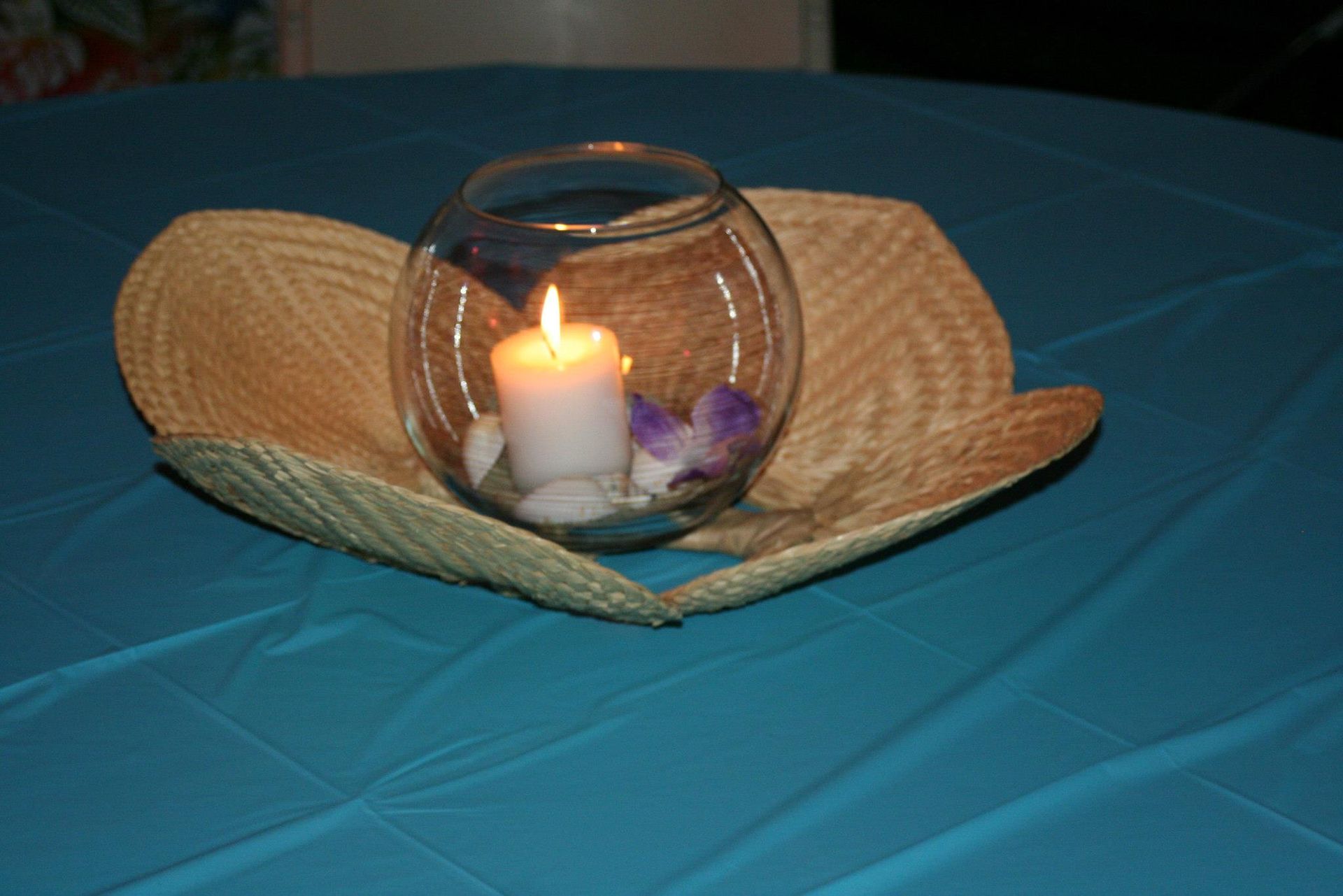 A wicker bowl with a candle inside of it