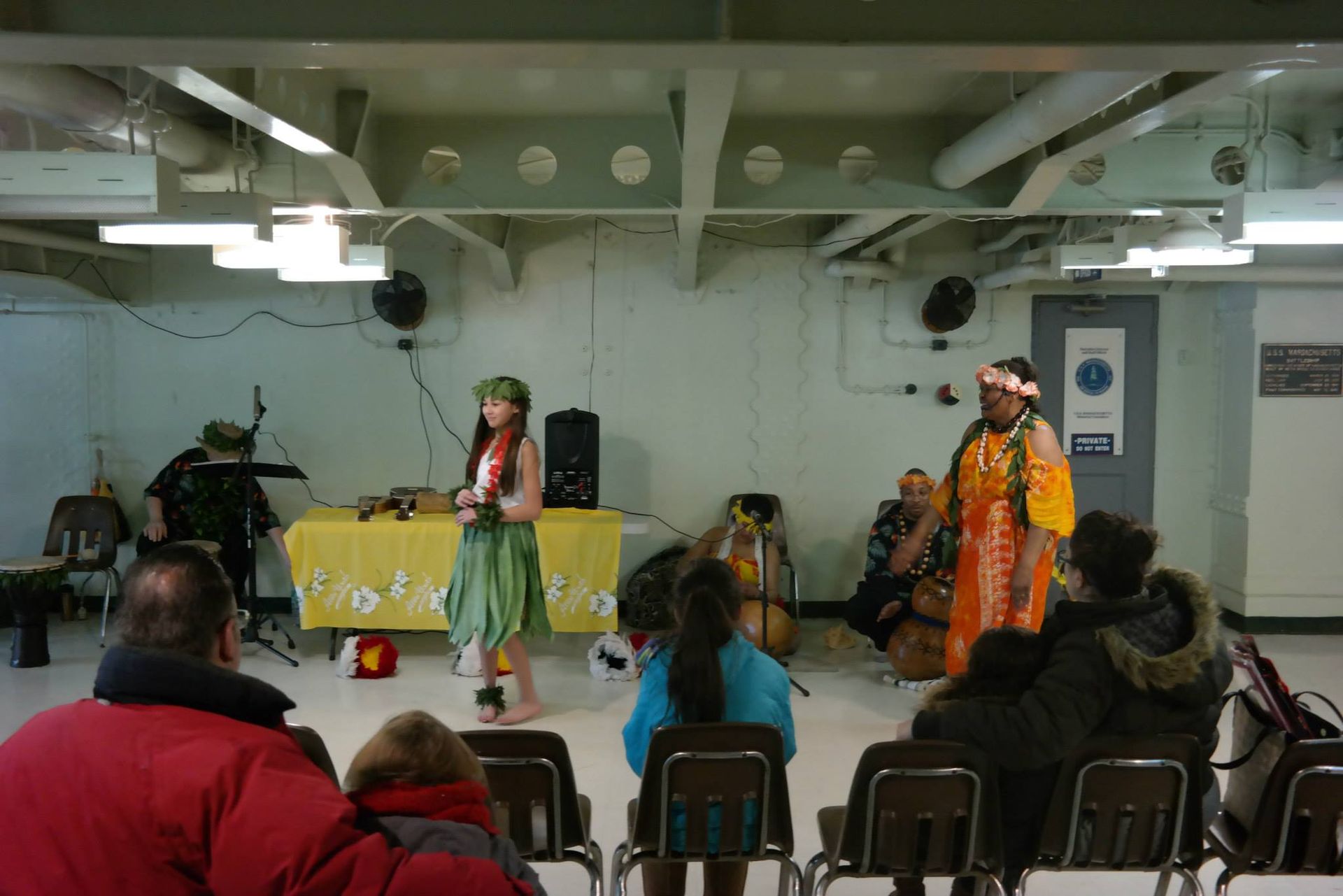 A group of people sitting in chairs watching a performance