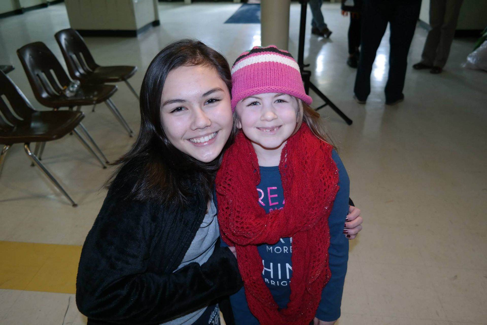 Two girls posing for a picture with one wearing a shirt that says re