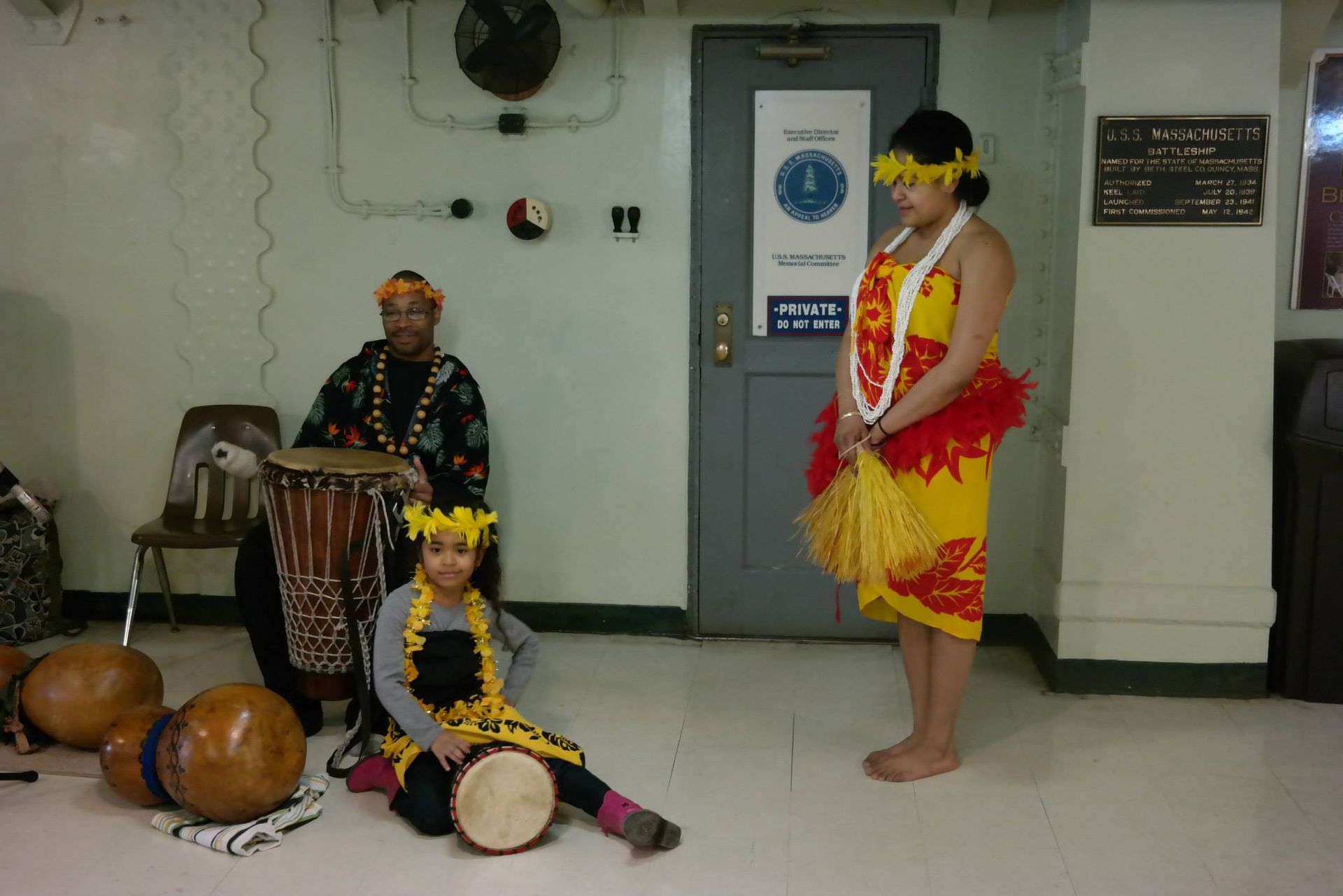 A woman in a yellow dress is standing in front of a door