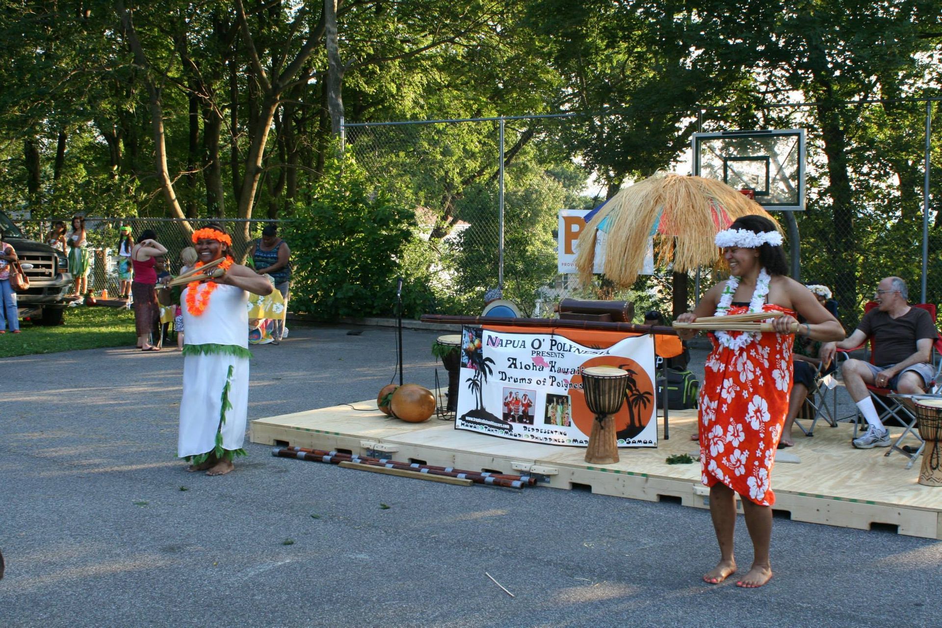 A woman in a hawaiian outfit is standing on a stage