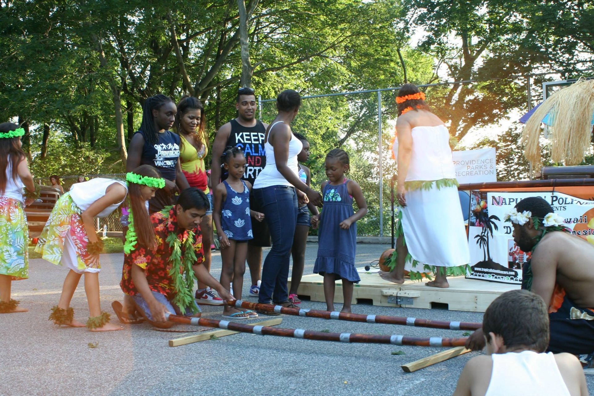 A group of people standing in front of a sign that says maple