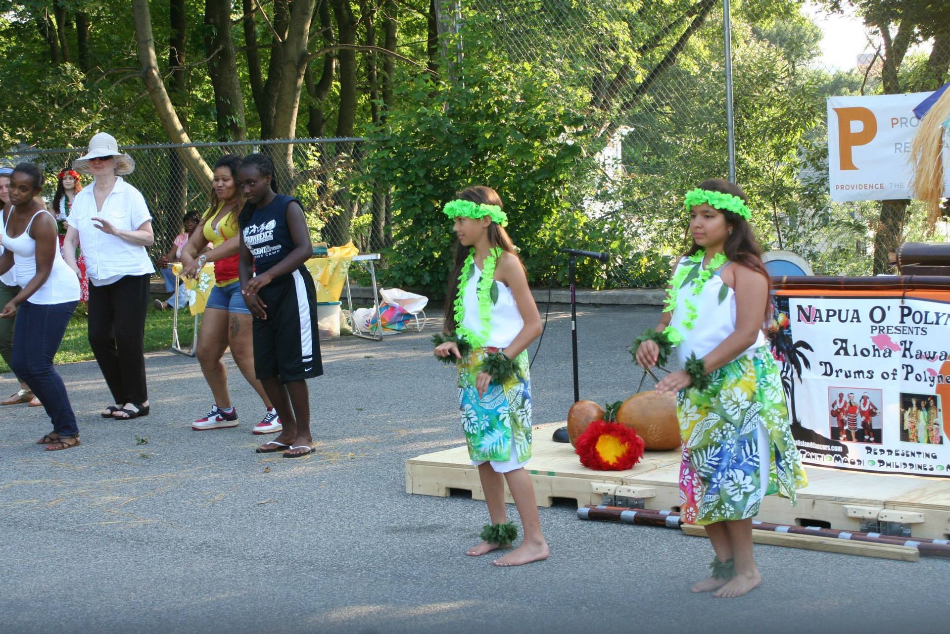 A group of people are dancing in front of a sign that says ' no parking '