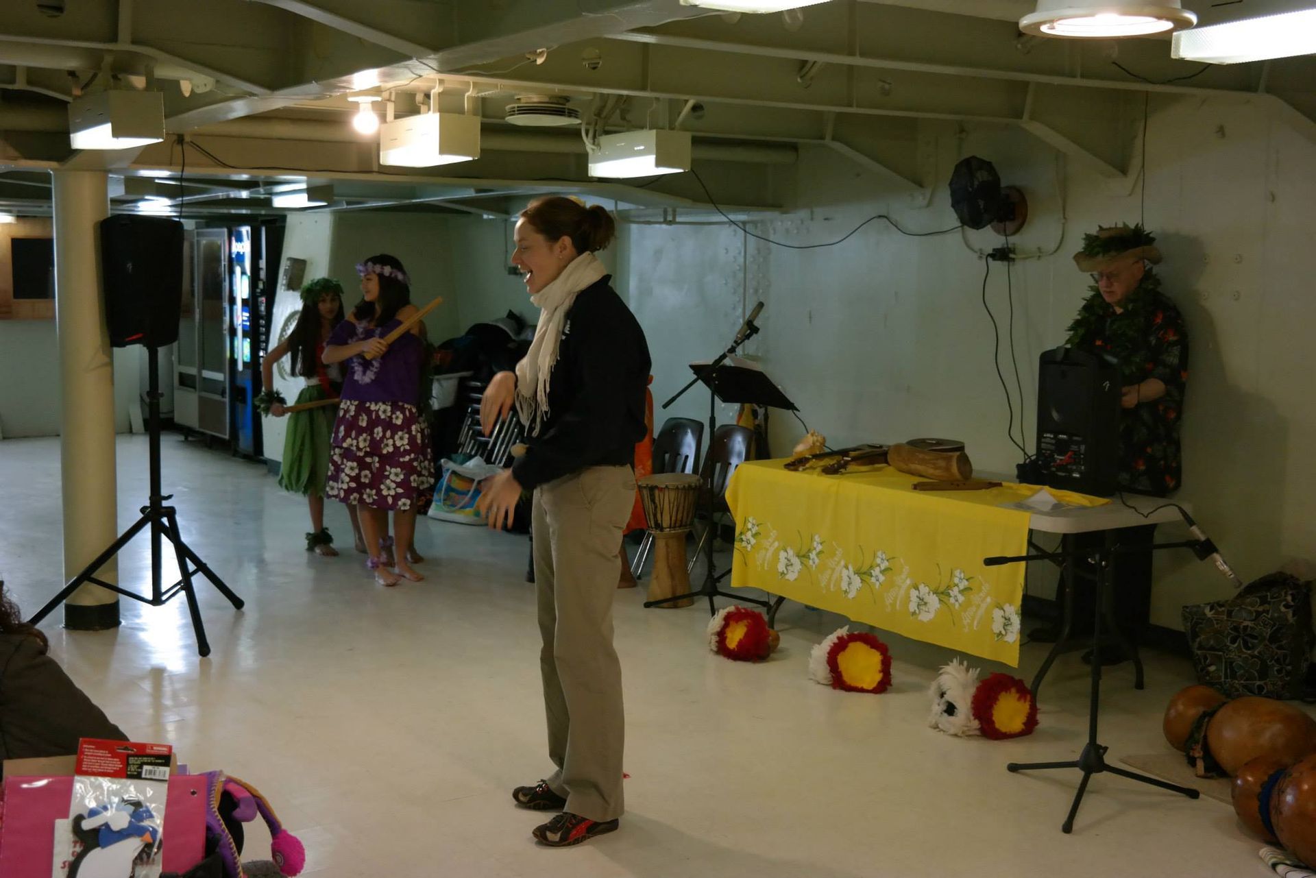 A group of people are dancing in a room with a man playing an accordion