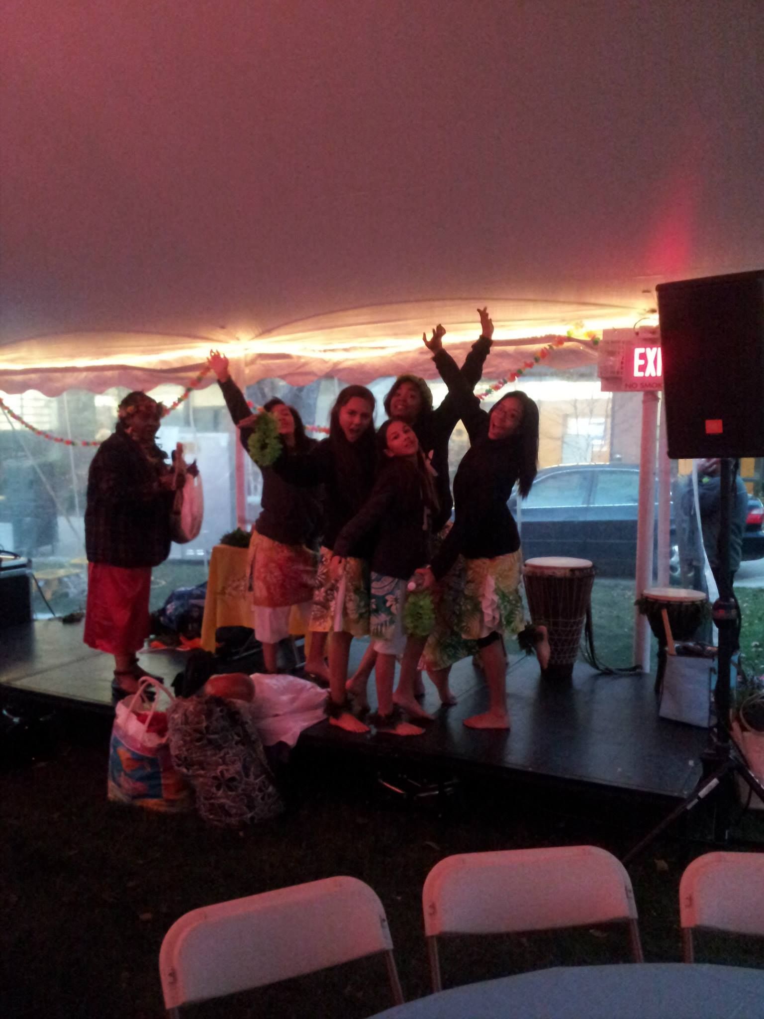 A group of people standing on a stage with a sign that says exit