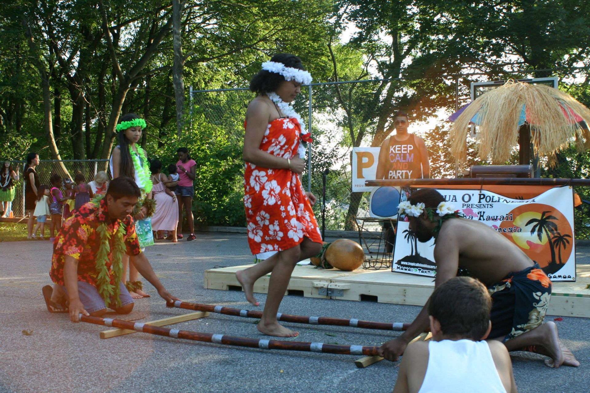 A group of people dancing in front of a sign that says p on it