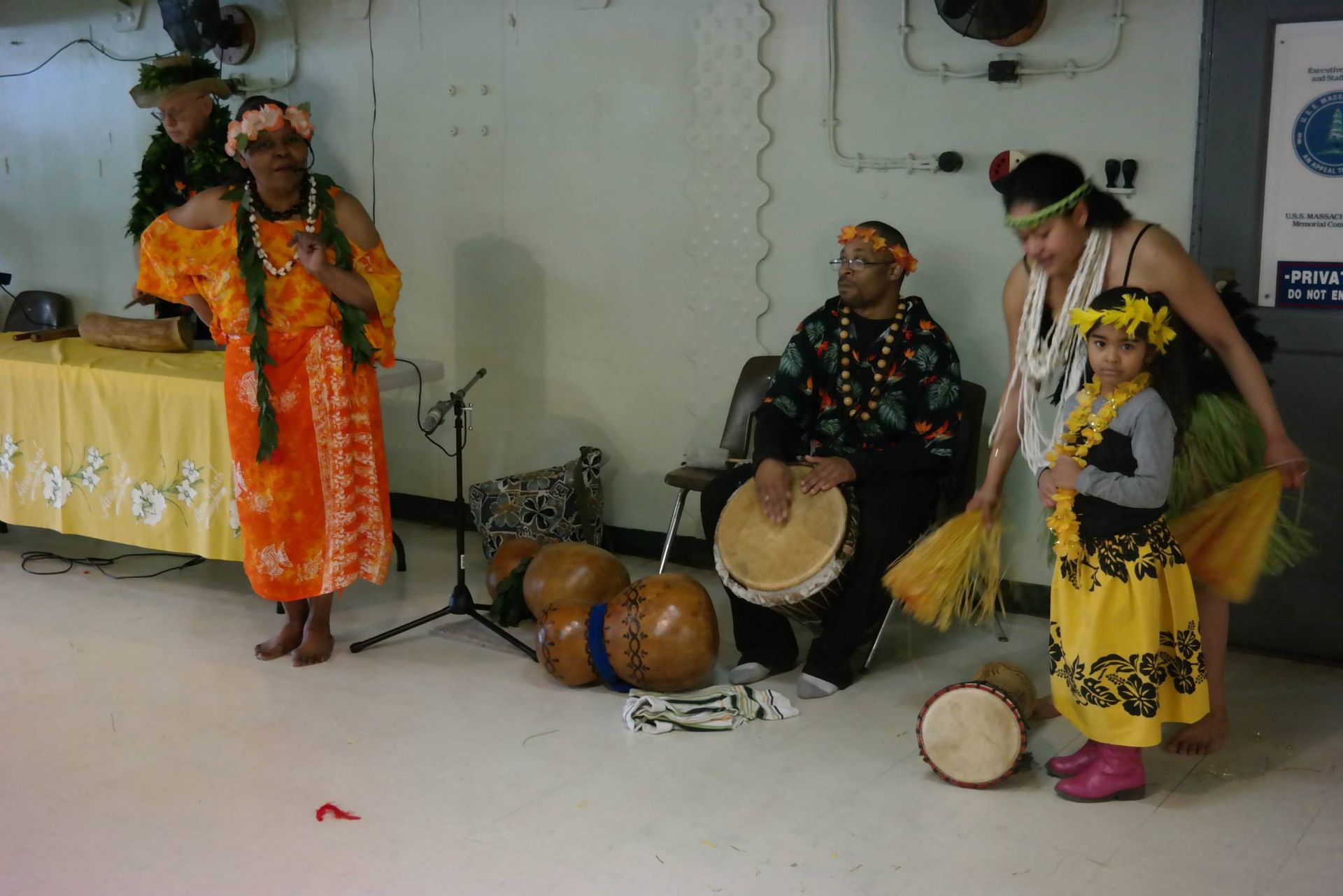 A group of people are playing drums in a room