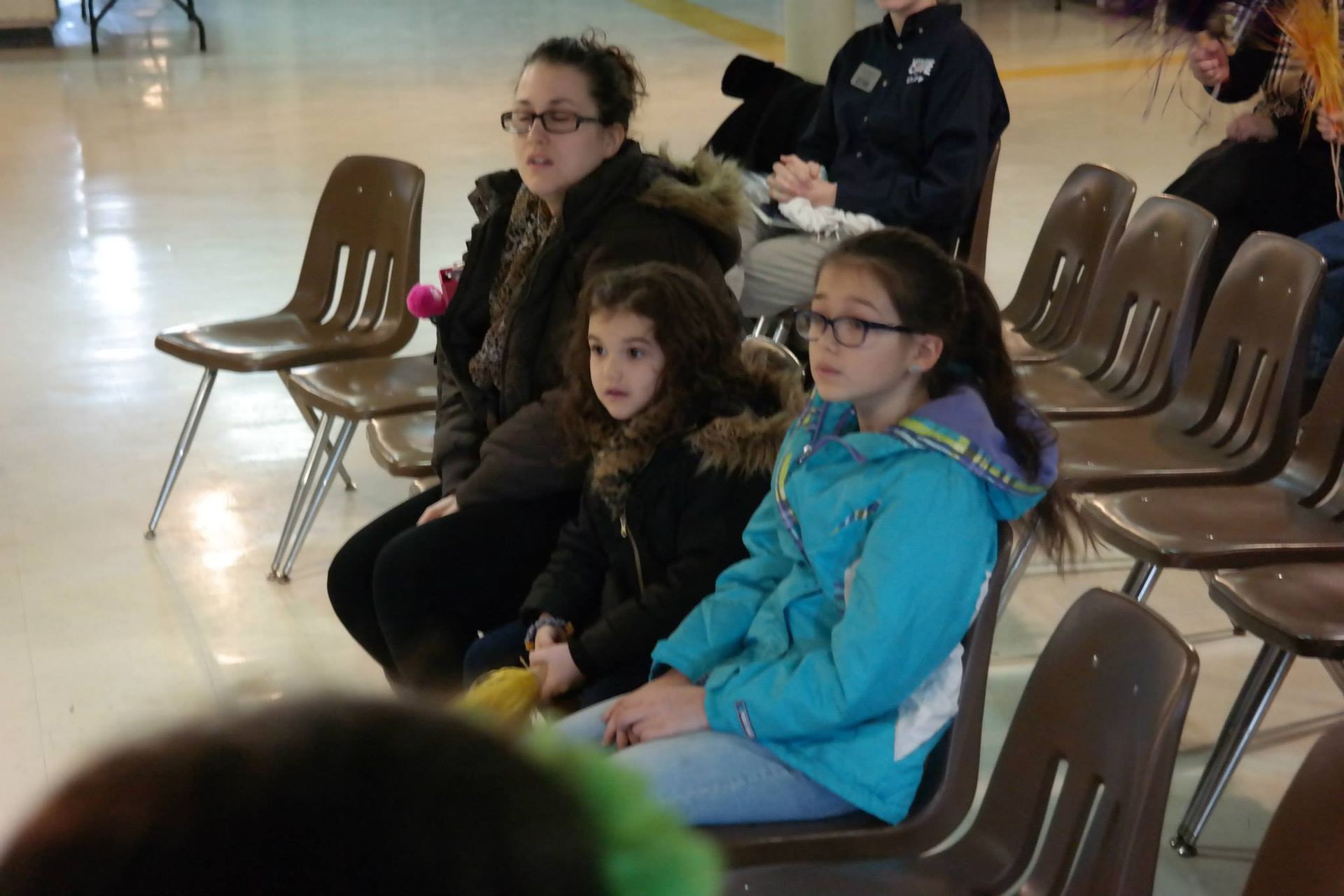 A group of people are sitting in chairs in a room