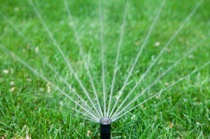 Commercial Grass Landscaping — Water Sprinkler on Grass in Fort Myers, FL