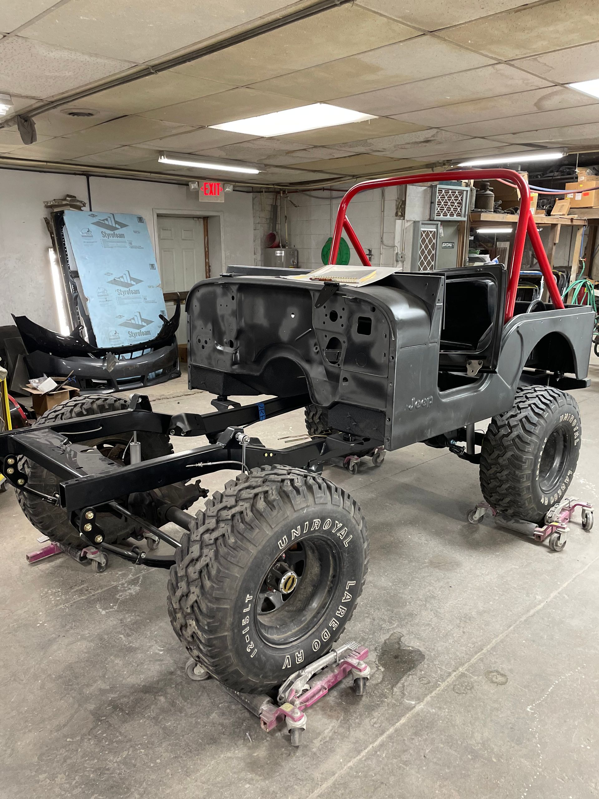 A jeep is being built in a garage.
