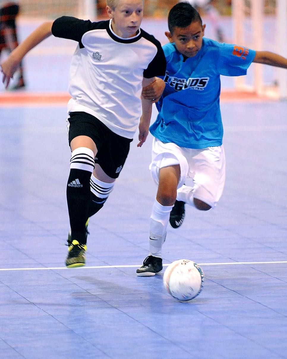 Soccer ball on a green field near a white line.