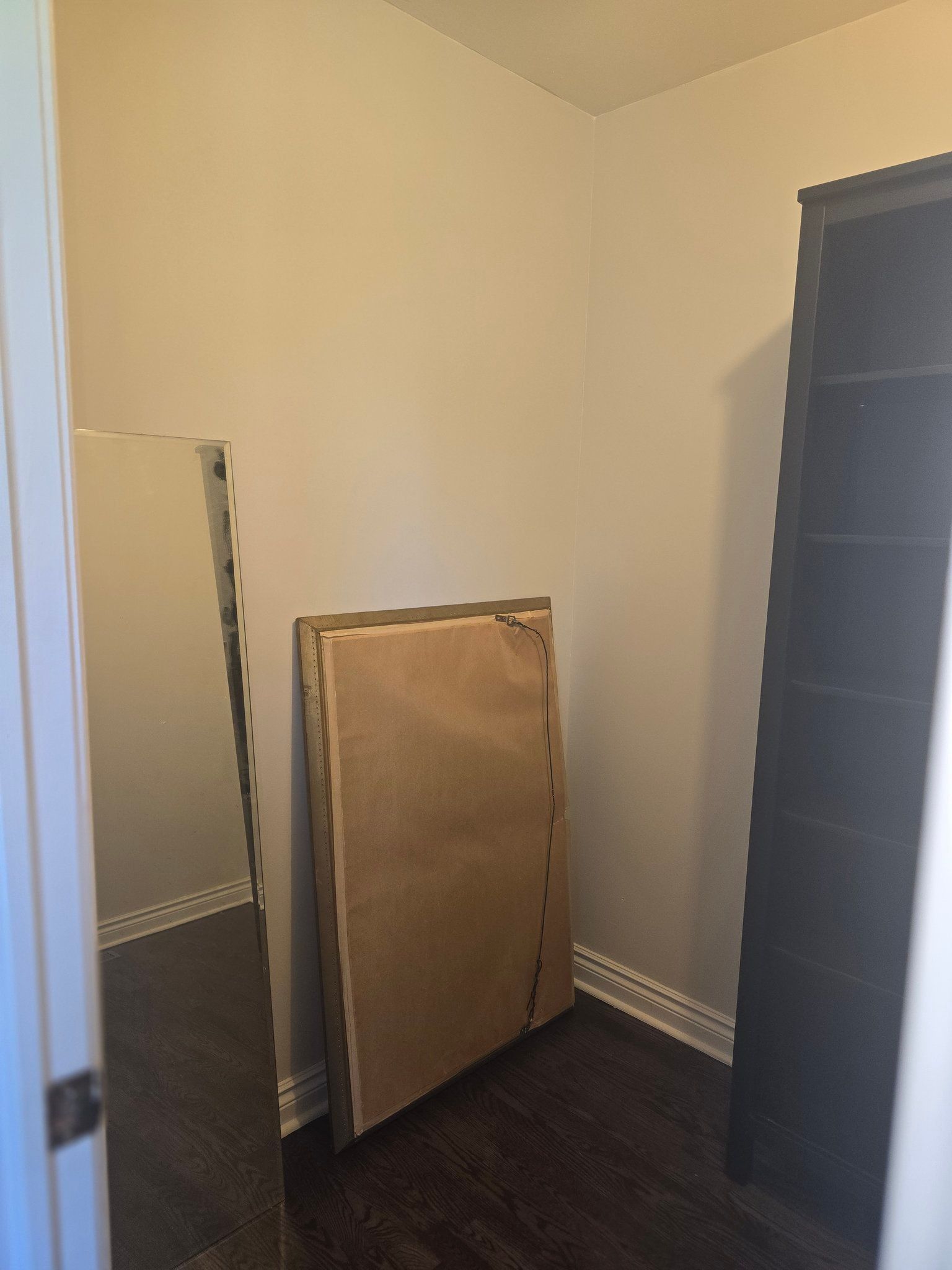 A room with a mattress and a mirror in it