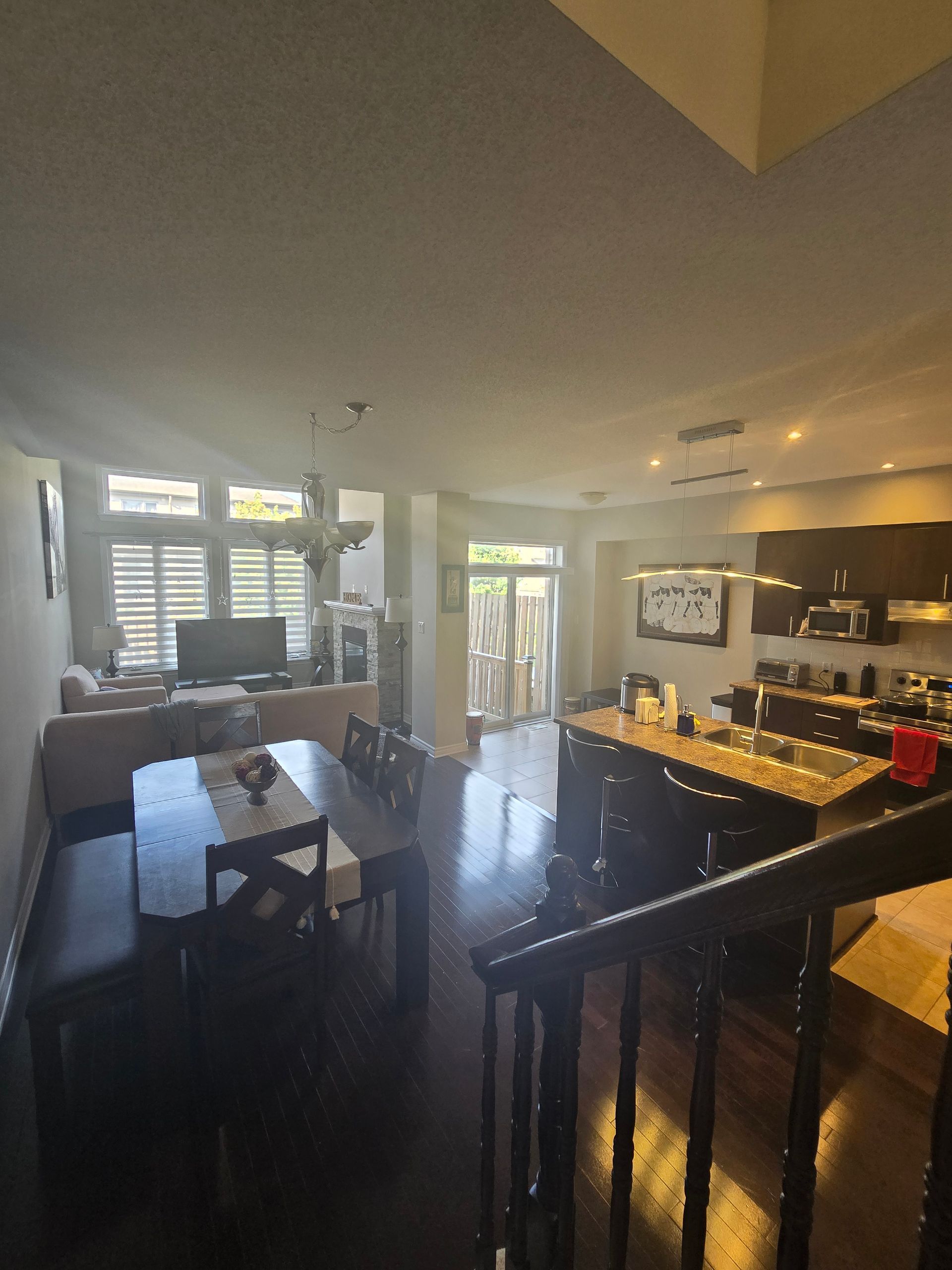 A living room with a dining table and chairs and a kitchen