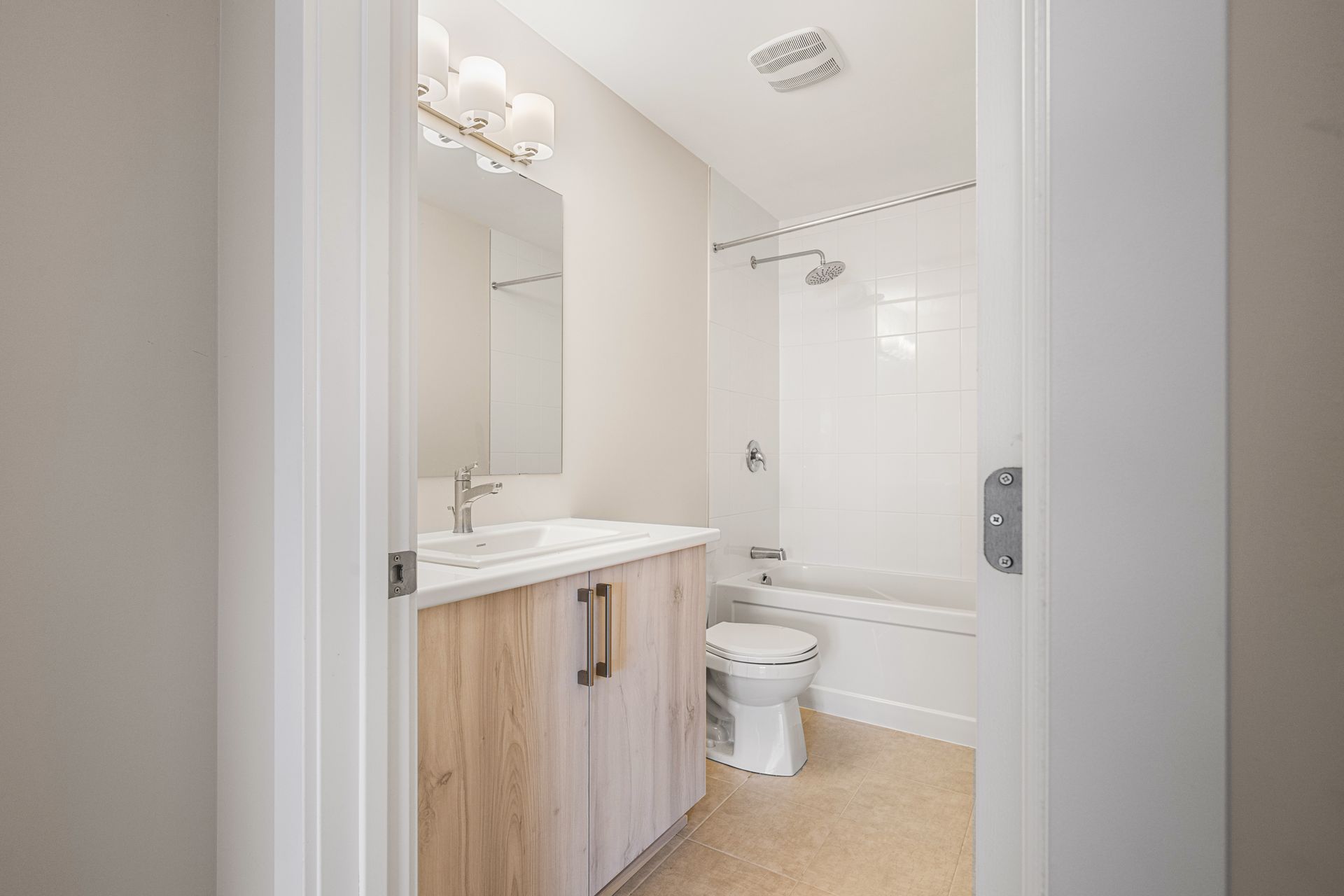 A bathroom with a sink , toilet , bathtub and mirror.