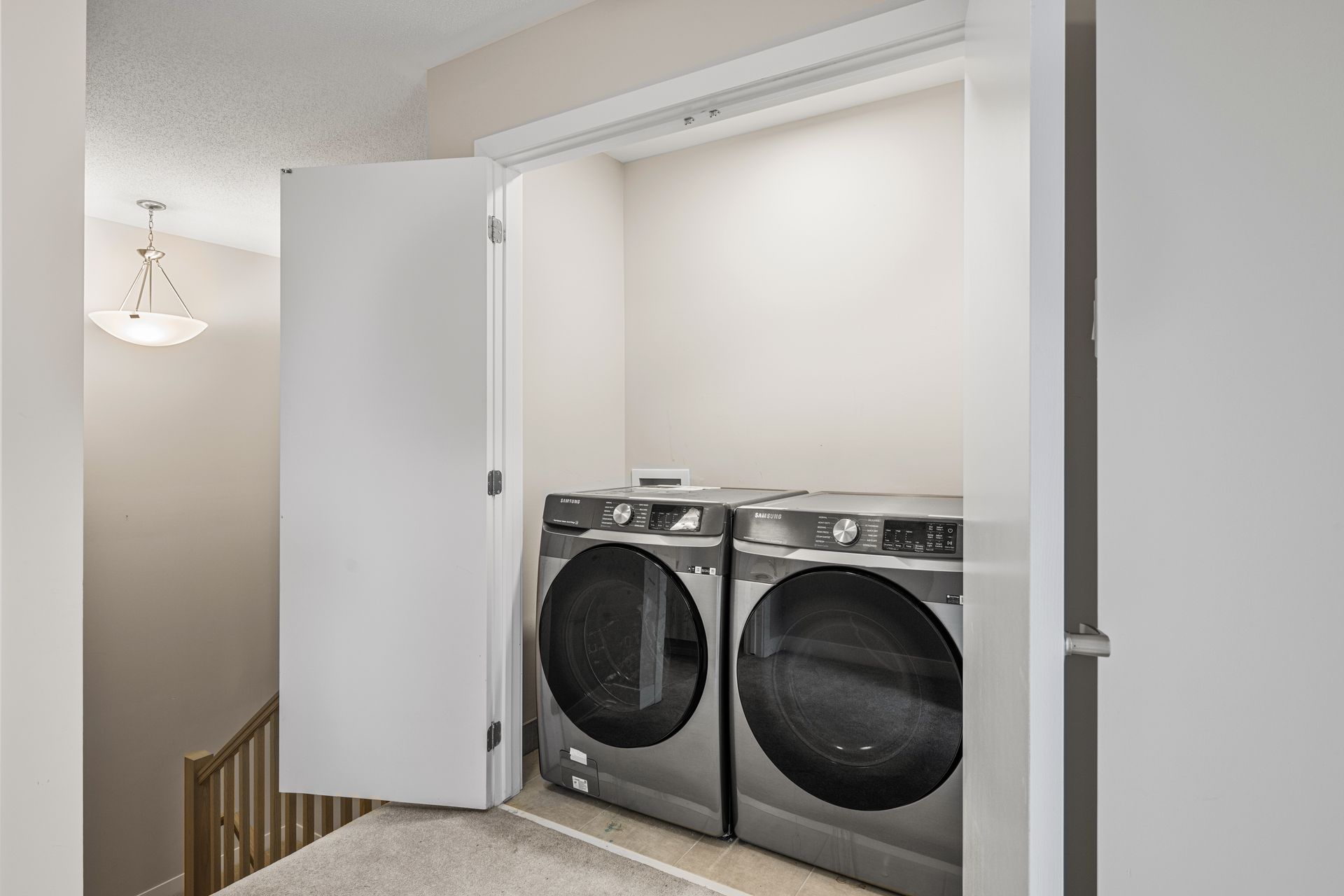 A laundry room with a washer and dryer in a closet.
