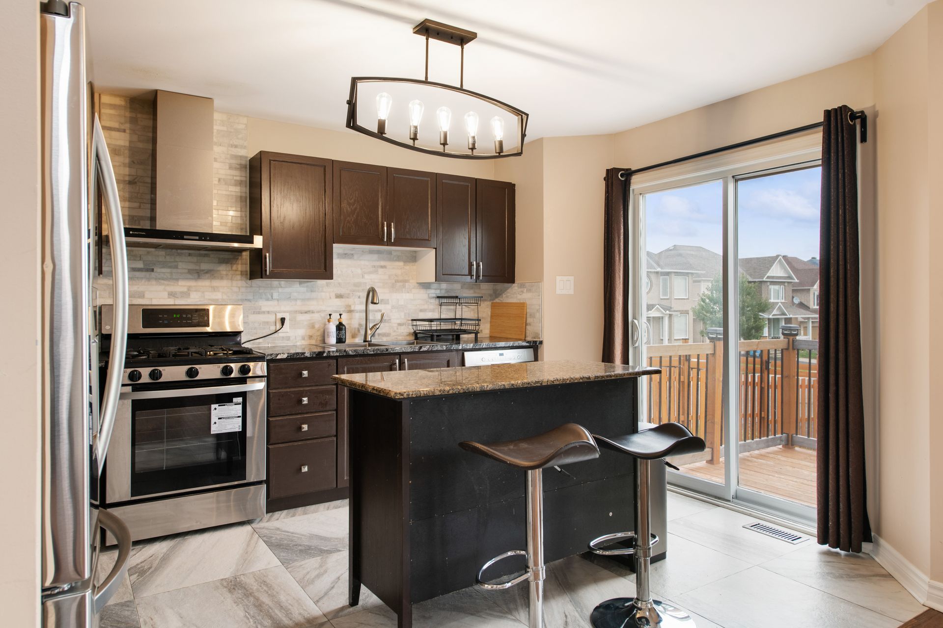 A kitchen with stainless steel appliances and a large island